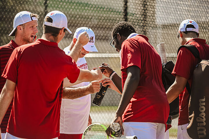 An IU Southeast Men's Tennis player returns a ball.